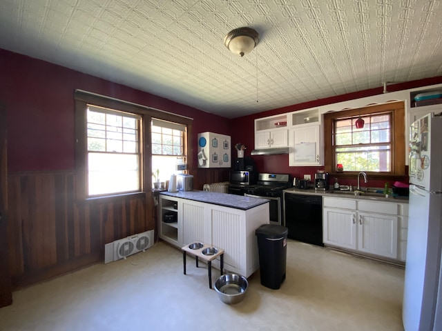 kitchen with dishwasher, white refrigerator, stainless steel range oven, sink, and white cabinetry