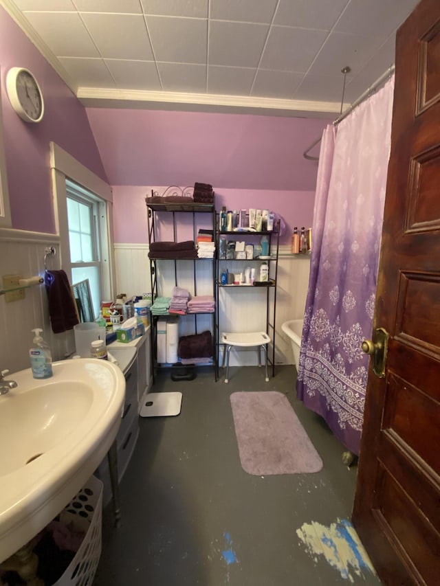 bathroom with concrete floors, a shower with curtain, sink, and toilet