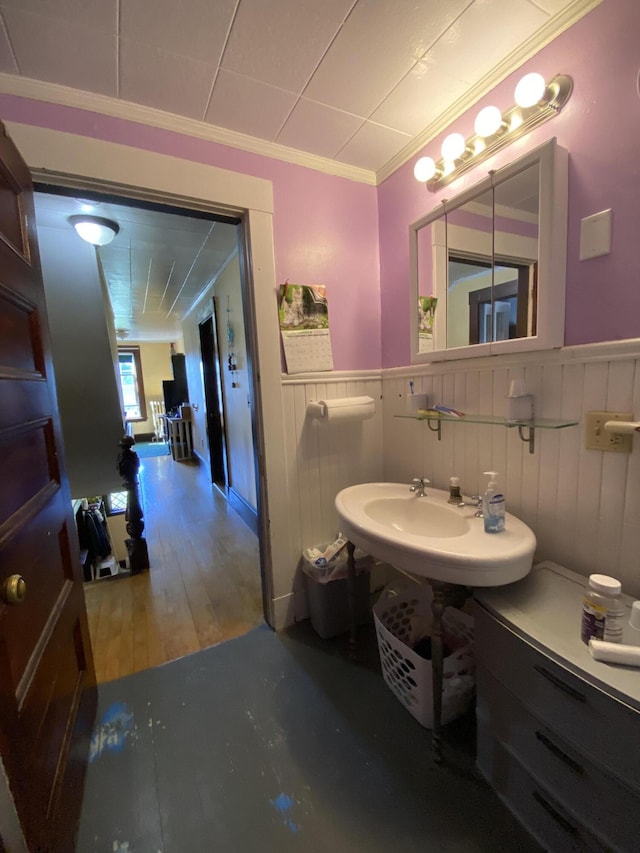 bathroom featuring ornamental molding, sink, and hardwood / wood-style flooring