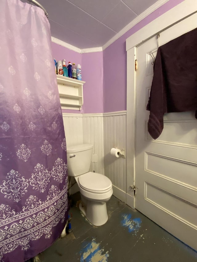 bathroom with ornamental molding and toilet