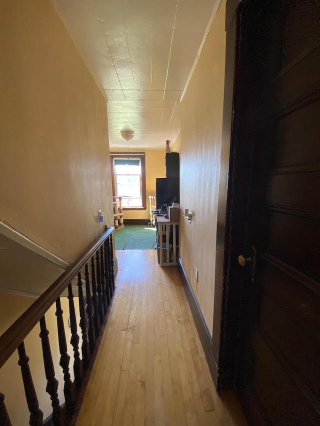 corridor with hardwood / wood-style floors