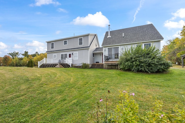 rear view of property with a lawn and a deck