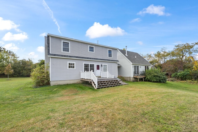 back of house with a lawn and a deck