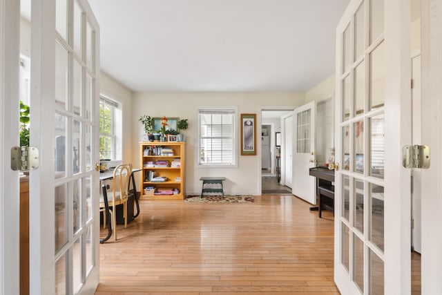 interior space featuring light wood-type flooring and french doors