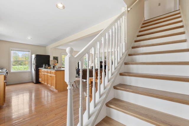 stairs with hardwood / wood-style flooring