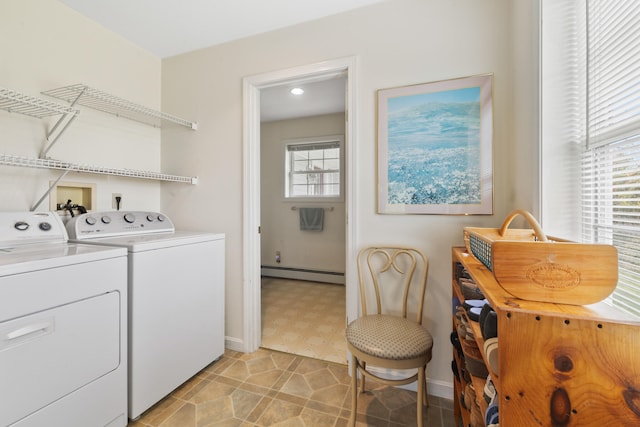 laundry area with a baseboard heating unit, plenty of natural light, and washing machine and clothes dryer