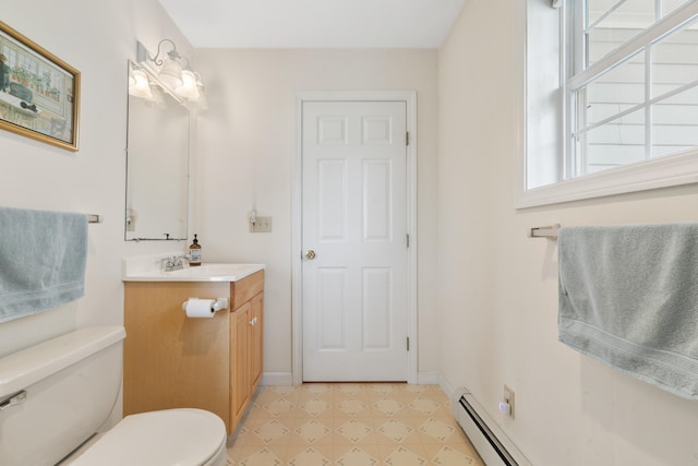 bathroom with vanity, toilet, and a baseboard heating unit