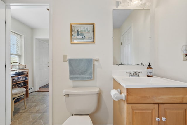 bathroom featuring vanity, baseboard heating, and toilet