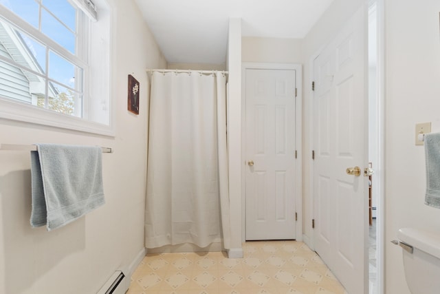 bathroom featuring a shower with shower curtain, a baseboard radiator, and toilet