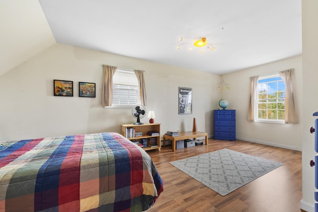 bedroom with lofted ceiling and hardwood / wood-style floors