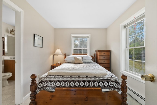 bedroom featuring connected bathroom, multiple windows, baseboard heating, and light tile patterned floors