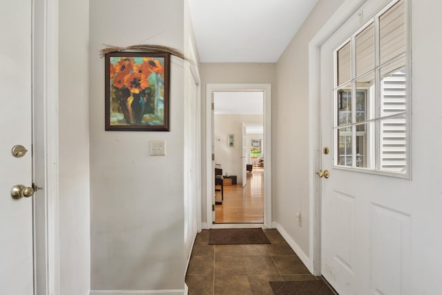 entryway with dark tile patterned flooring