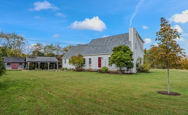 rear view of property featuring a lawn