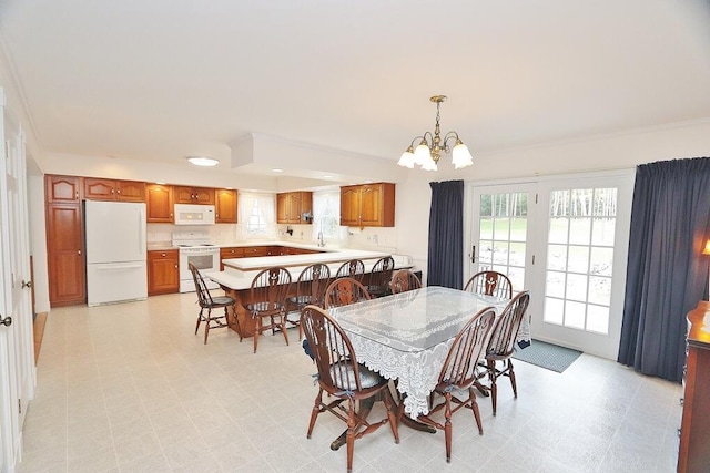 dining area with a notable chandelier and sink