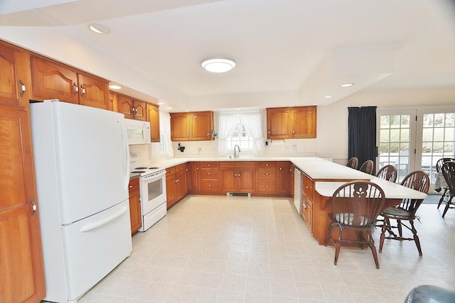 kitchen featuring sink, plenty of natural light, and white appliances