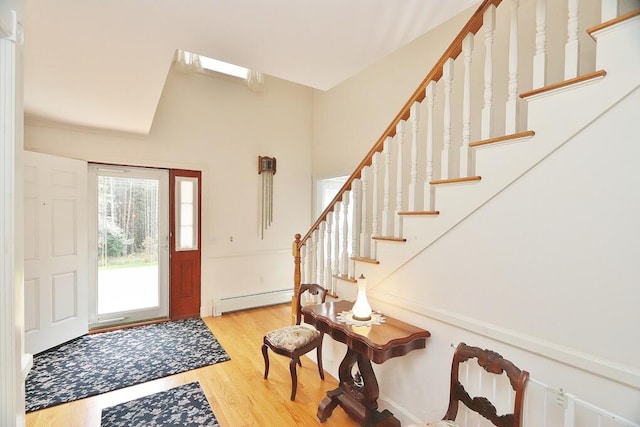 foyer featuring a baseboard heating unit and light hardwood / wood-style floors