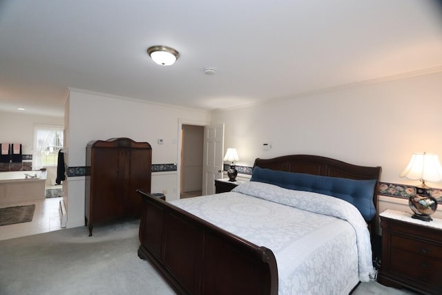 bedroom with ornamental molding and light colored carpet