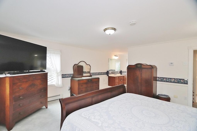 carpeted bedroom featuring crown molding and a baseboard heating unit