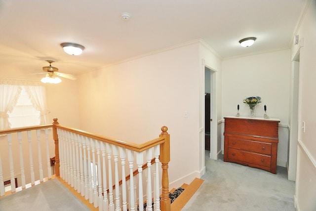 hall featuring crown molding and light colored carpet