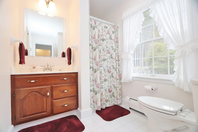 bathroom with toilet, vanity, and a baseboard radiator