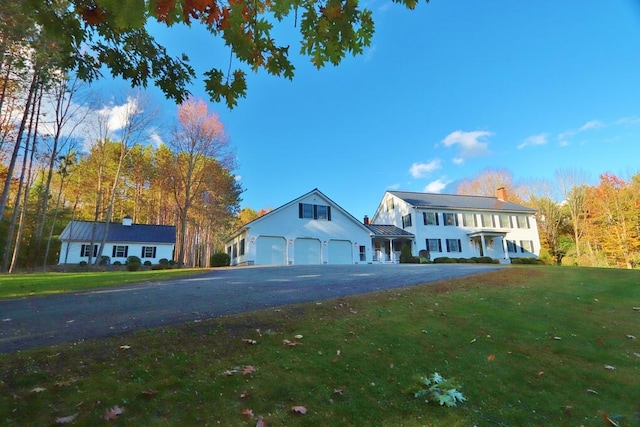 view of front of property featuring a garage and a front lawn