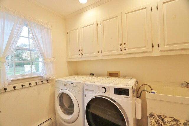 laundry area with a baseboard heating unit, sink, crown molding, cabinets, and washing machine and clothes dryer