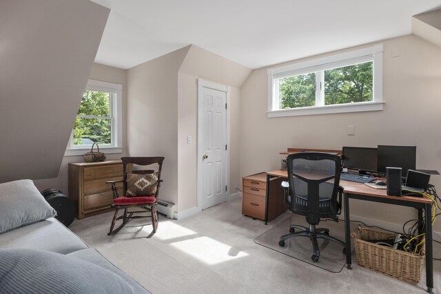 carpeted home office with vaulted ceiling and a healthy amount of sunlight