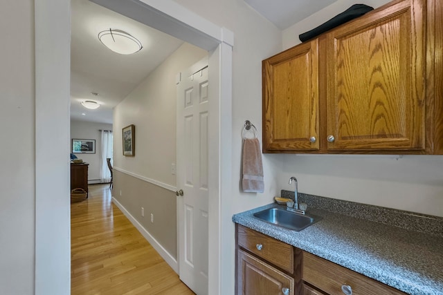 interior space with light hardwood / wood-style floors and sink