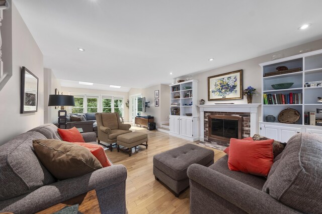 living room with a fireplace and light hardwood / wood-style flooring