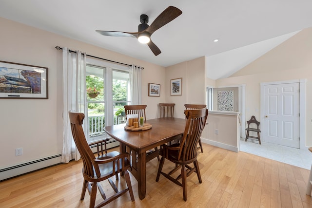 dining space with vaulted ceiling, light hardwood / wood-style floors, baseboard heating, and ceiling fan