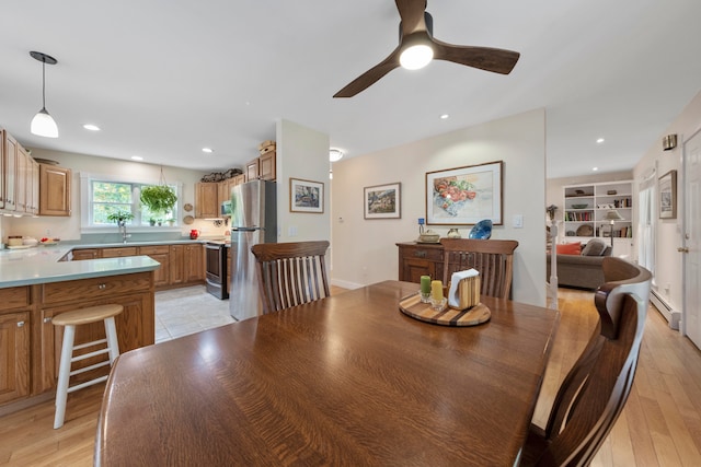 dining room featuring ceiling fan and light wood-type flooring