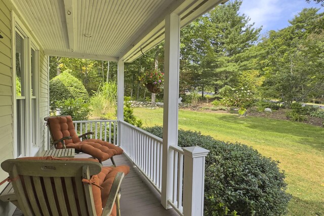 wooden terrace featuring a yard