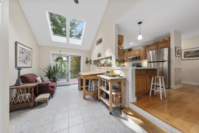 living room with light wood-type flooring and lofted ceiling with skylight