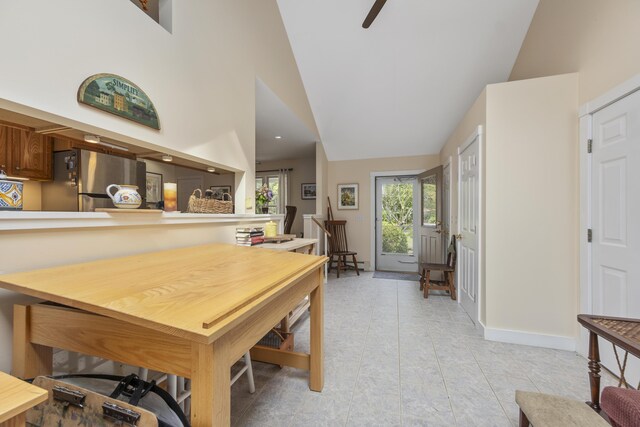 tiled dining room with high vaulted ceiling