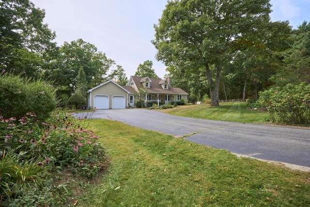 cape cod-style house featuring a front lawn and a garage