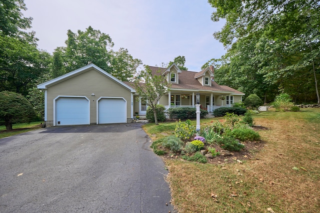 new england style home with a garage and covered porch