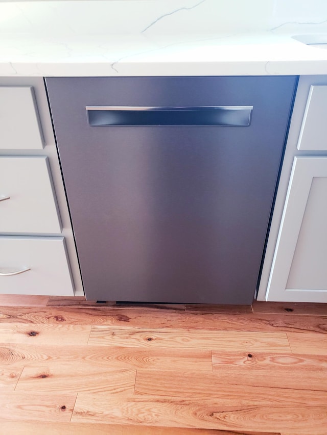 room details featuring dishwasher and light hardwood / wood-style flooring