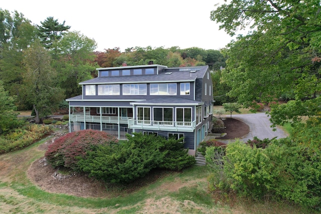 back of house with a sunroom