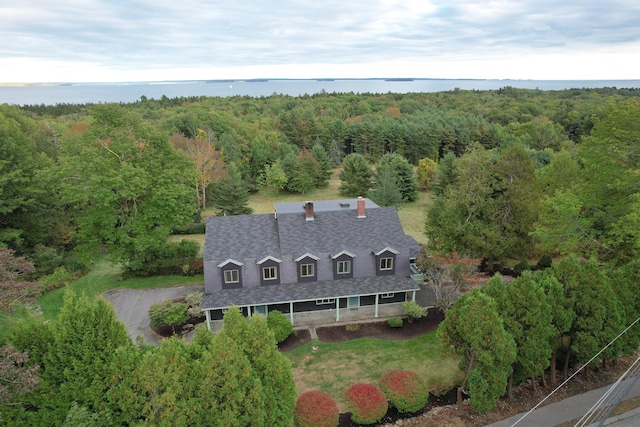 aerial view with a wooded view and a water view