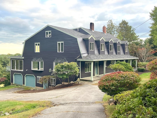 view of front facade with a porch and a garage