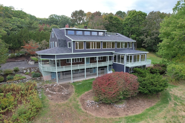 back of property with a sunroom