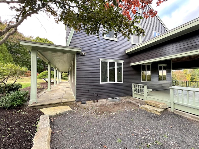 rear view of property with a deck and a patio area