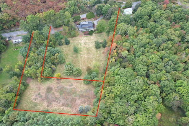 birds eye view of property with a wooded view