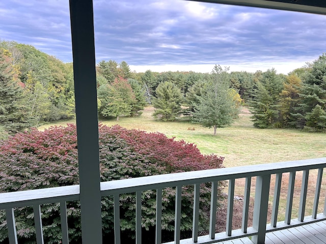 balcony featuring a forest view