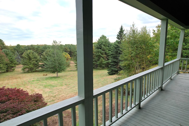 wooden terrace featuring a yard