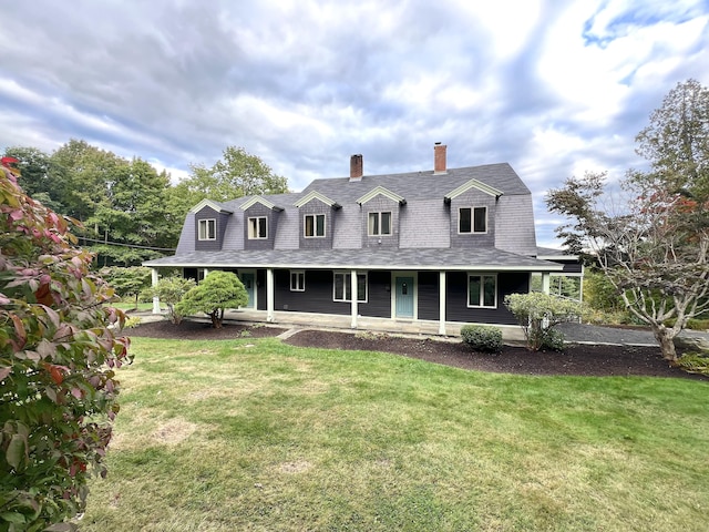 cape cod home with a gambrel roof, covered porch, roof with shingles, a front lawn, and a chimney