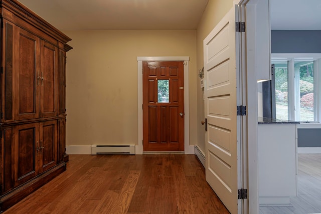 doorway featuring hardwood / wood-style flooring and baseboard heating