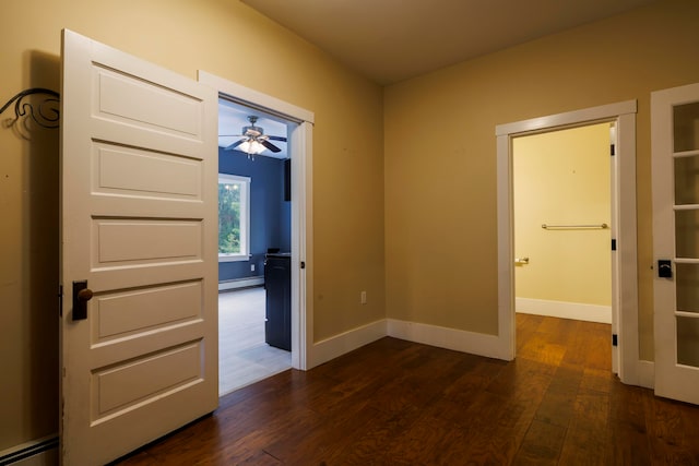 interior space with dark hardwood / wood-style floors and a baseboard heating unit