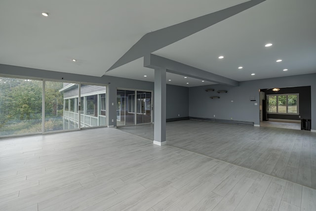 interior space featuring recessed lighting, light wood finished floors, and baseboards