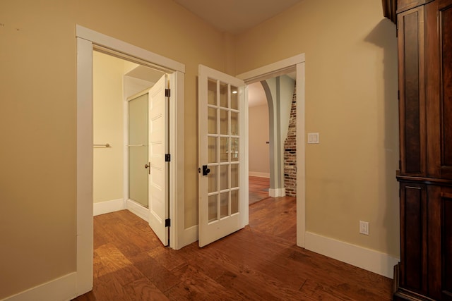 hallway with hardwood / wood-style flooring